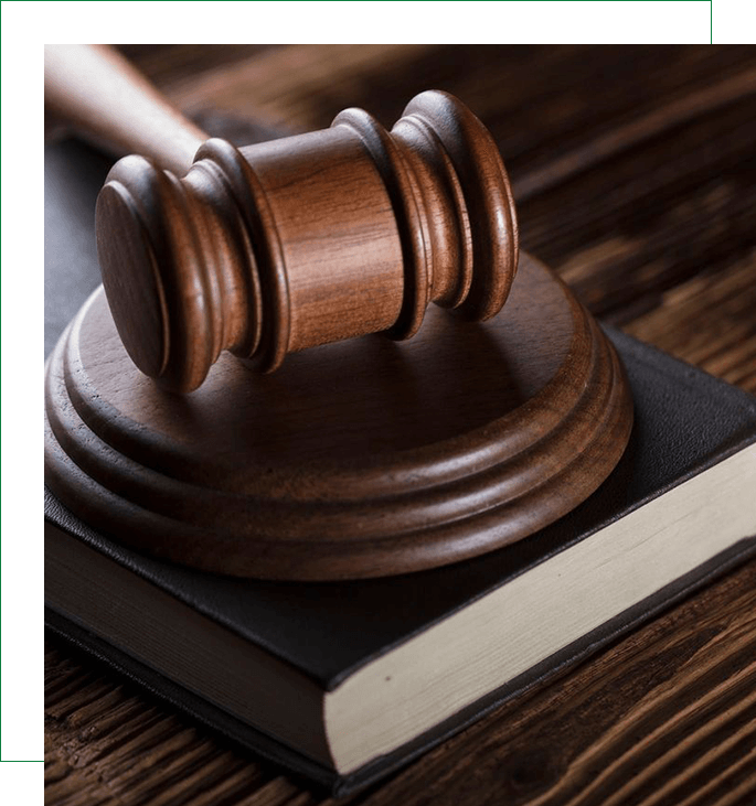 A wooden judge 's gavel on top of a book.